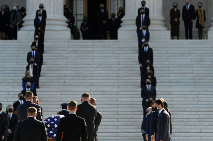 Law clerks and other mourners as Ruth Bader Ginsburg's casket is carried up the steps of the US Supreme Court