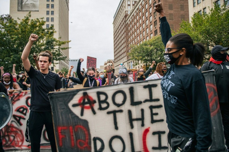 Demonstrators march in the streets of Louisville following the announcement of charges in the fatal police shooting of Breonna Taylor