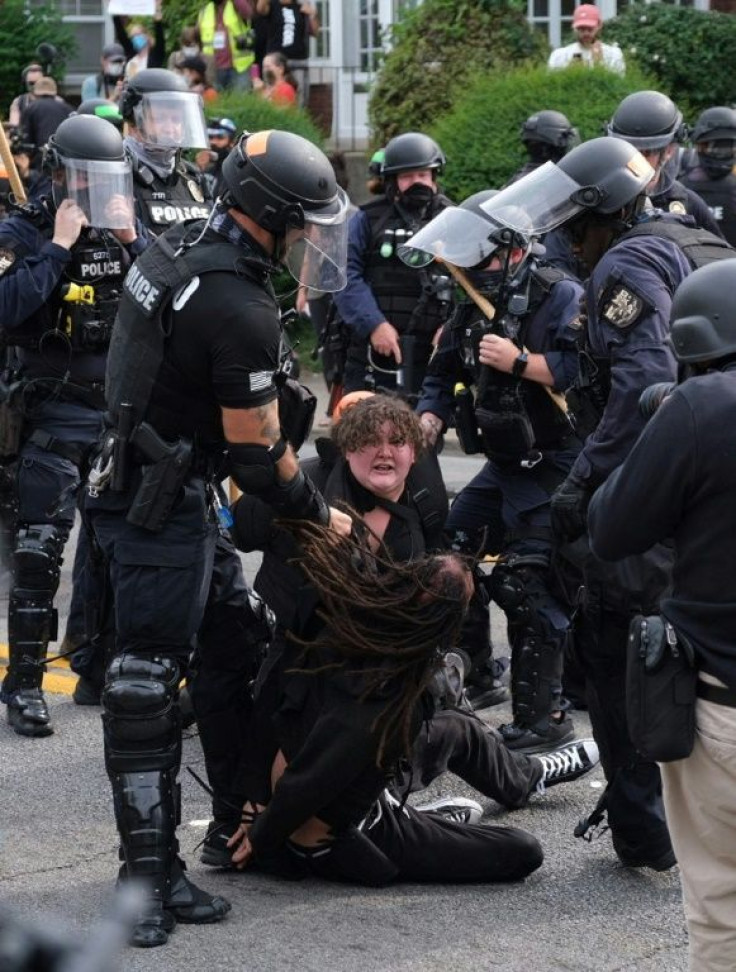 Riot police arrest protesters in Louisville after charges were announced in the Breonna Taylor case