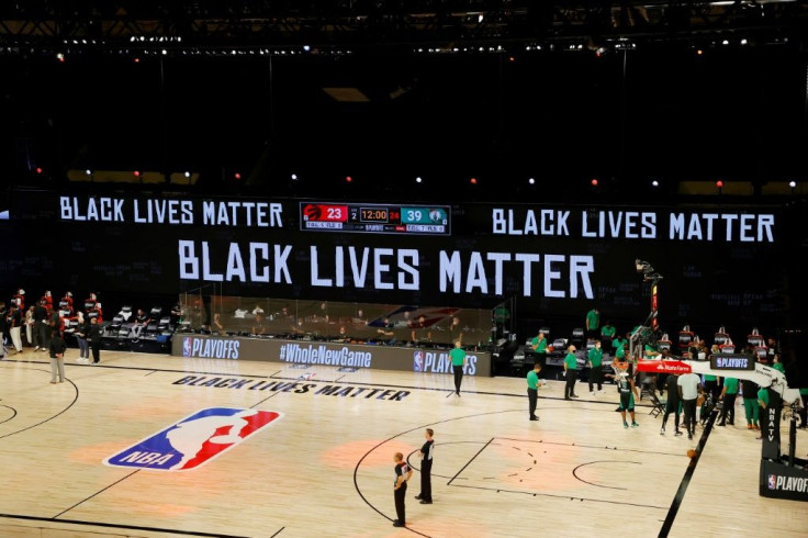 Black Lives Matter is displayed on the boards during an NBA playoff game between the Toronto Raptors and Boston Celtics