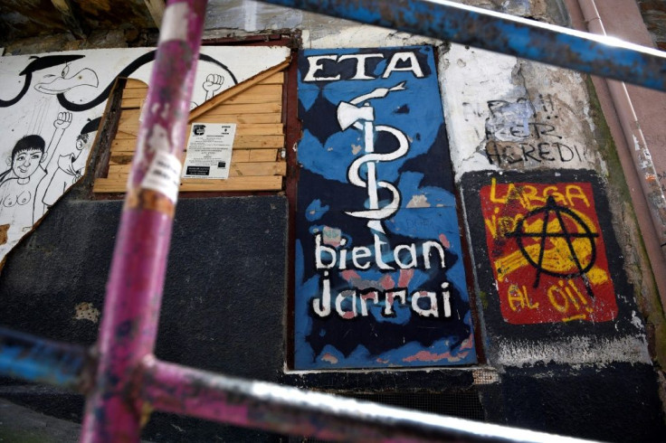 (FILES) This file photo taken on March 30, 2017 shows a graffiti representing the logo of the armed Basque separatist group ETA in the northern Spanish Basque village of Bermeo. Ten years after ETA renounced its armed struggle, few will speak of the blood