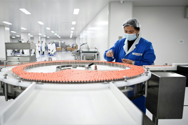 A staff member works during a media tour of a new factory in Beijing built to produce a Covid-19 vaccine at Sinovac, one of 11 Chinese companies approved to carry out clinical trials