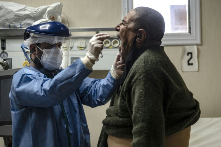 A doctor takes samples from a man with Covid-19 symptoms at the Doctor Alberto Antranik Eurnekian Public Hospital on the outskirt of Buenos Aires in August 2020