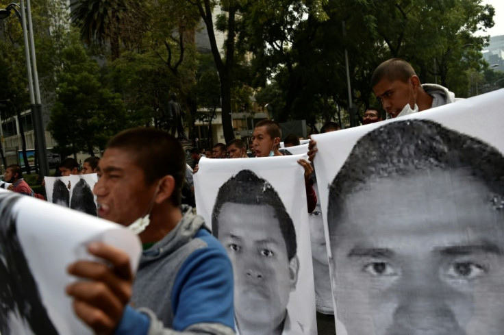 Demonstrators carried large pictures of the 43 students of the teaching training school in Ayotzinapa who went missing on September 26, 2014