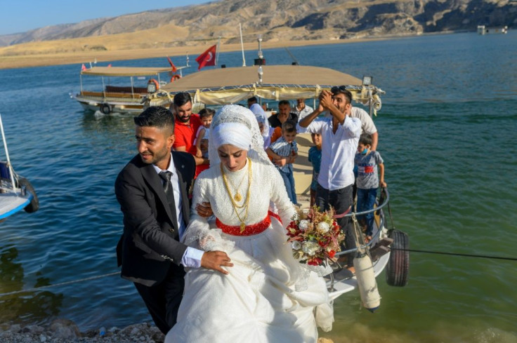 Cetin Yildirimer, a 29-year-old former tour guide, celebrated on a boat with his new wife before the couple move into one of the homes built for the original town's residents.