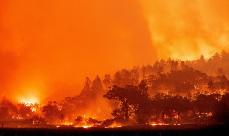 In this long exposure photograph, burning hills create a flaming landscape during the Glass fire in Napa County's St. Helena, California on September 27, 2020, described by authorities as a wildfire with a 'dangerous rate of spread.'