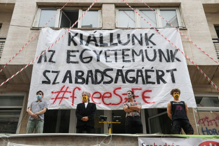 Teachers and students stand guard on top of the main entrance of the University of Theatre and Film Arts