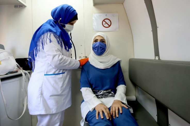 Midwife Khoudary examines a woman at a mobile clinic in Beirut's Basta area
