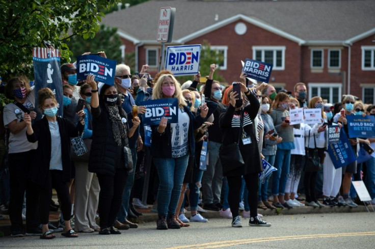 Supporters of Democratic presidential nominee Joe Biden cheered outside the Greensburg Train Station in Greensburg, Pennsylvania as Biden made a stop there on a train tour across battleground states Ohio and Pennsylvania