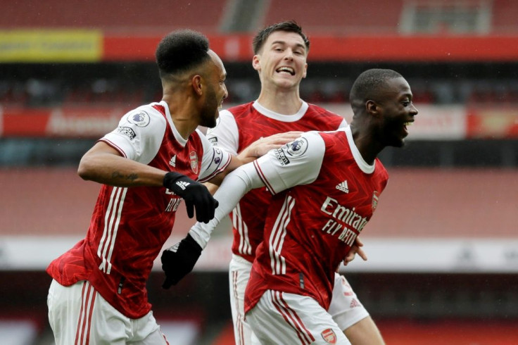 All smiles: Nicolas Pepe's (right) goal gave Arsenal a 2-1 win over Sheffield United