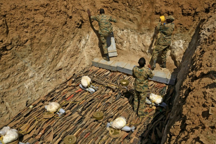 Rifles taken from the public in Sudan are placed in a pit before they are blown up -- there some 2.76 million illegally-held weapons in Sudan in 2017, or 6.6 guns for every 100 people, experts estimate