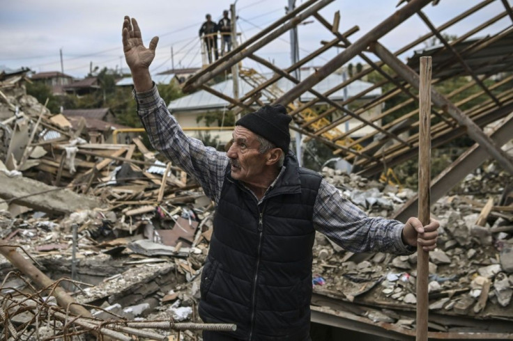 Retired police officer Genadiy Avanesyan, 73, searches for belongings in the remains of his house in the city of Stepanakert on October 10, 2020