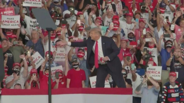 IMAGESIn his first campaign rally since contracting Covid-19, US President Donald Trump takes the stage in Sanford, Florida, himself maskless, and throws red masks out into the audience instead of the usual Make America Great Again baseball caps. Trump ha