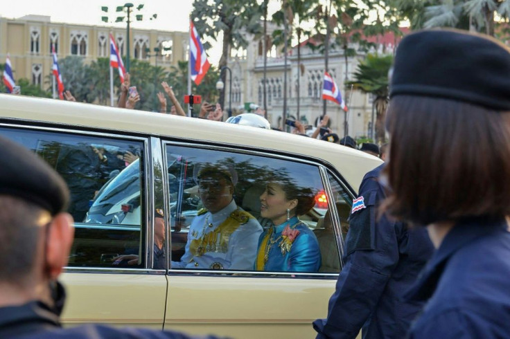 Thailand's Queen Suthida (C) and Prince Dipangkorn Rasmijoti (centre L) were in the royal motorcade