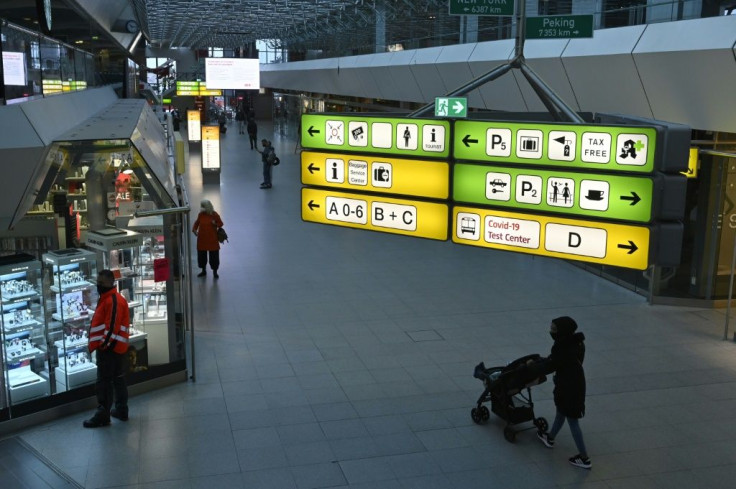 A sign indicates the direction to a testing centre for the novel coronavirus at the Main Hall of Tegel Airport in Berlin on Wednesday