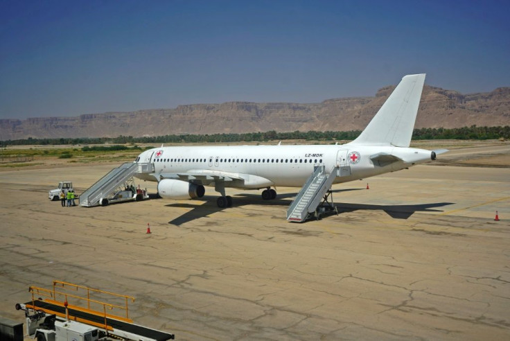 A Red Cross plane sits on the tarmac in Yemen's government-held city of Seiyun, waiting to ferry home combatants released as part of a landmark prisoner swap