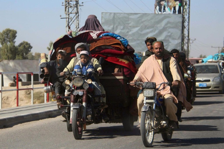 Afghans flee from Nadali district to Lashkar Gah during clashes between Taliban fighters and Afghan security forces on October 12, 2020