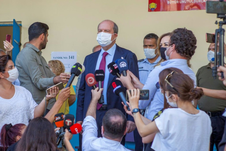 Ersin Tatar, one of two contenders to be elected leader of the self-proclaimed Turkish Republic of Northern Cyprus (TRNC), speaks to reporters after casting his ballot on Sunday