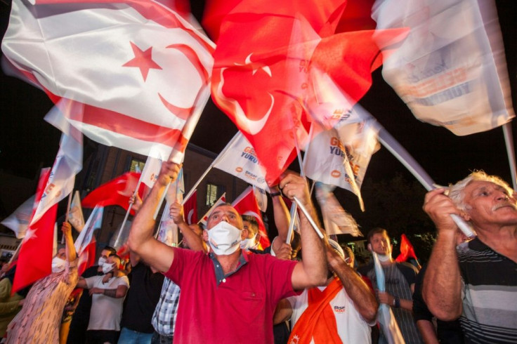Supporters of right-wing Turkish Cypriot nationalist Ersin Tatar celebrate his win in the presidential election in northern Nicosia