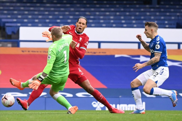 Everton goalkeeper Jordan Pickford (left)went unpunished for his shocking tackle on Van Dijk (centre)