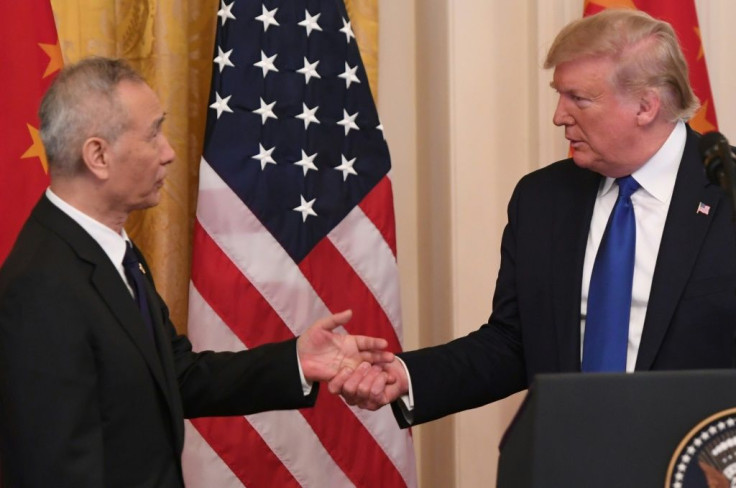 US President Donald Trump shakes hands during a press conference with China's Vice Premier Liu He (L) inJanuary 2020 -- the "phase one" trade deal with China mandated Beijing step up purchases of US farm products