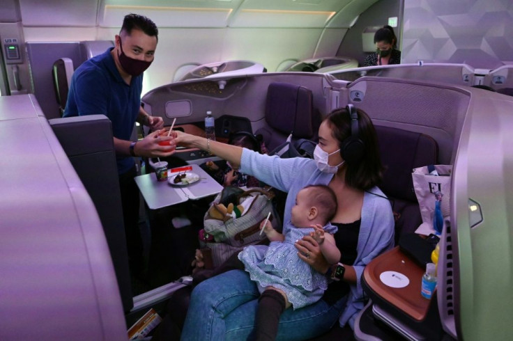 A couple and their children dine in business class