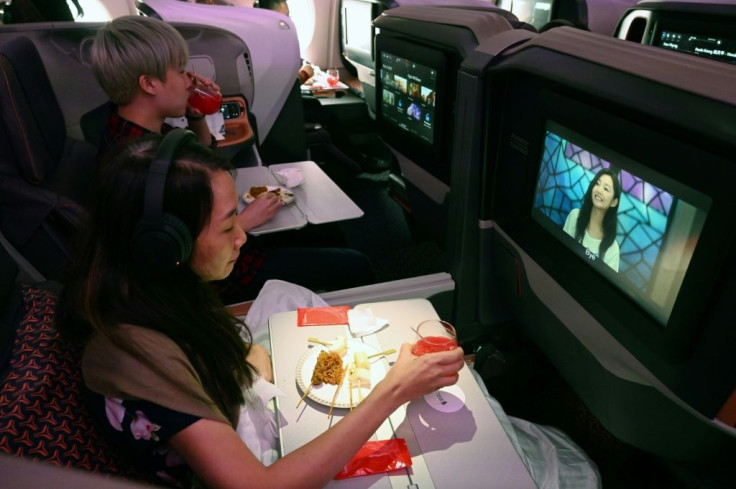 Diners watch movies while dining in business class