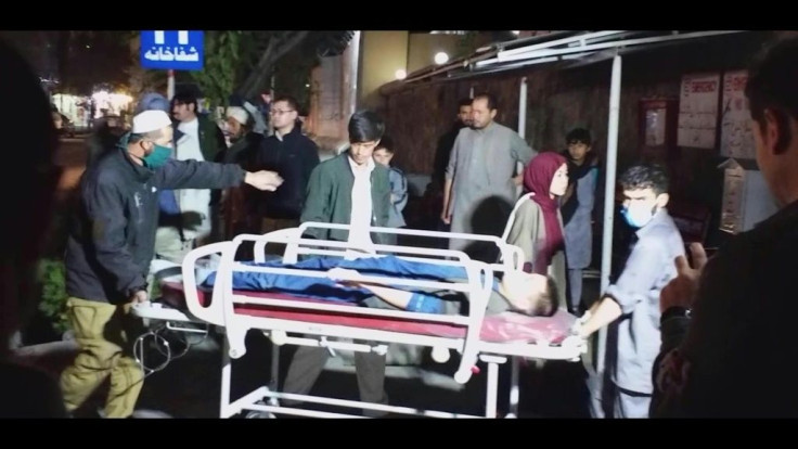 Afghan nurses carry the wounded to the hospital after a suicide bomb attack in Kabul