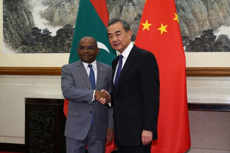 Chinese Foreign Minister Wang Yi shakes hands with Maldivian Foreign Minister Abdulla Shahid in Beijing in September 2019 as Beijing pursues ties in the archipelago