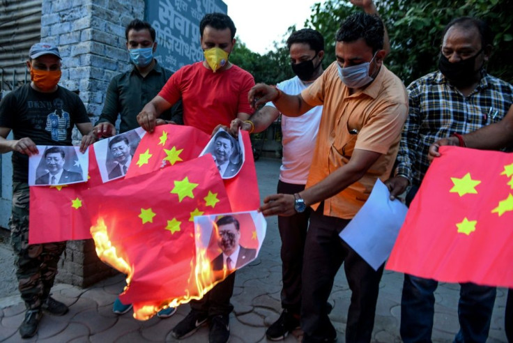 Proteters in the northern Indian city of Amritsar burn Chinese flags and pictures of Chinese President Xi Jinping in June 2020 after deadly border clashes