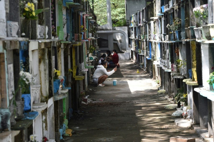 Filipinos pray at their dead relatives' resting places ahead of a week-long closure of cemeteries in Manila