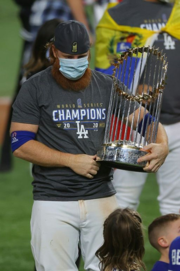 Justin Turner on the field with the World Series trophy after the Los Angeles Dodgers victory over the Tampa Bay Rays