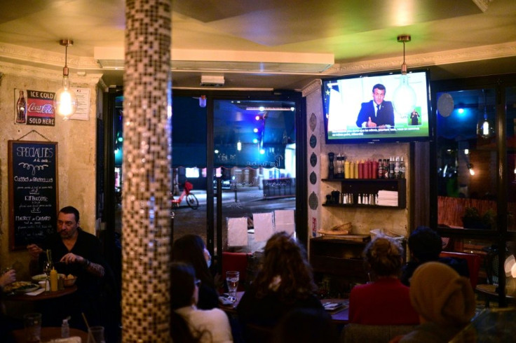 Clients at a Paris cafe watched President Emmanuel Macron's address on Wednesday, when he announced a new lockdown to combat a resurgent coronavirus  outbreak.