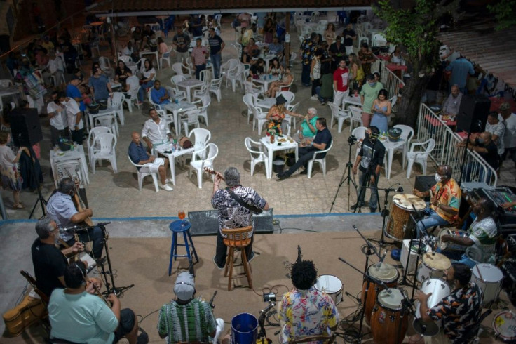 Brazilian musician Moacyr Luz (C), plays his acoustic guitar during a Samba do Trabalhador concert at Rio's Renascenca club on October 26, 2020