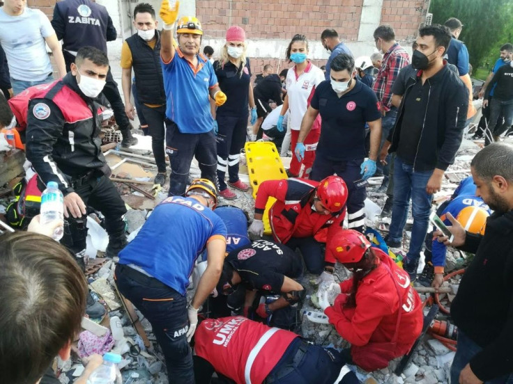 Rescuers search for survivors at a collapsed building in Izmir