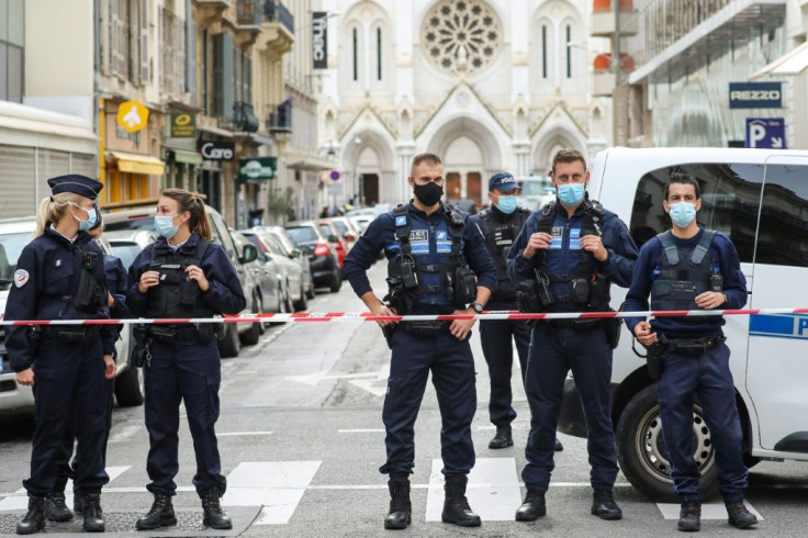 Police block access to the Notre-Dame de l'Assomption Basilica in Nice where a knife-wielding young Tunisian killed three people in an attack the authorities are treating as an act of "Islamist terror"