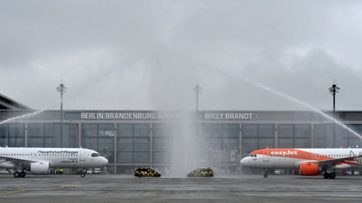 Fire engines sprayed water to greet the Lufthansa and Easyjet planes, the first flights to arrive at the new facility, opened nine years behind schedule