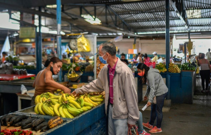 A man buy bananas at the municipal market of Chacao in Caracas amid the coronavirus pandemic on September 3, 2020 as inflation increases in Venezuela, which is in the midst of the worst economic crisis in its history