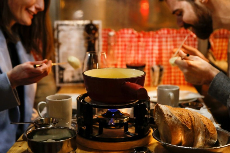 Swiss cheese fondue is traditionally involves several people dipping bread into the same pot