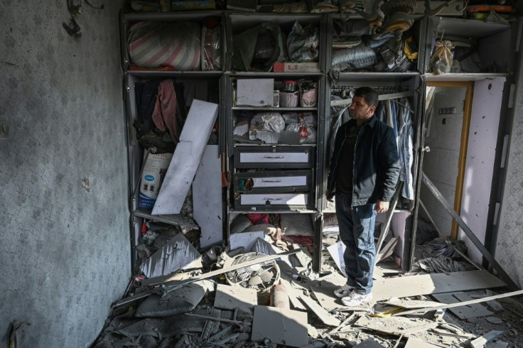 In Afghanistan, a man inspects a damaged house after several rockets landed on Saturday, that latest in a string of attacks