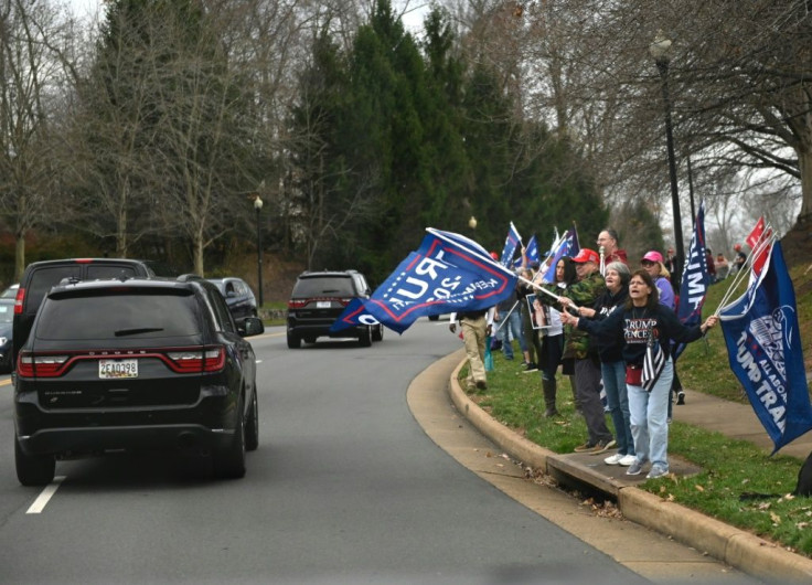 Supporters of US President Donald Trump cheer as he passes in the motorcade after golfing in Sterling, Virginia on November 21, 2020
