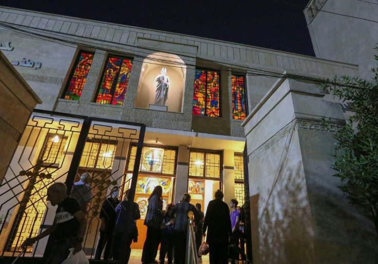 Worshippers leave after Mass at St. Joseph's Chaldean Cathedral in the Iraqi capital Baghdad