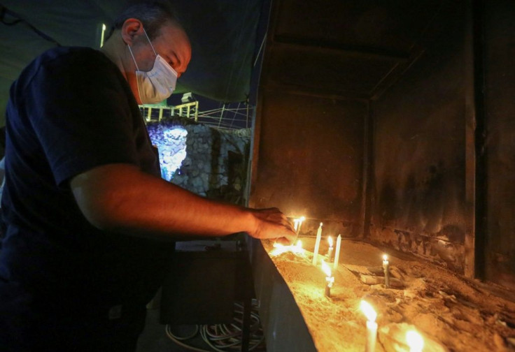 A worshipper lights a candle at St. Joseph's Chaldean Cathedral in the Iraqi capital Baghdad. A few hundred thousand Christians are left in the country