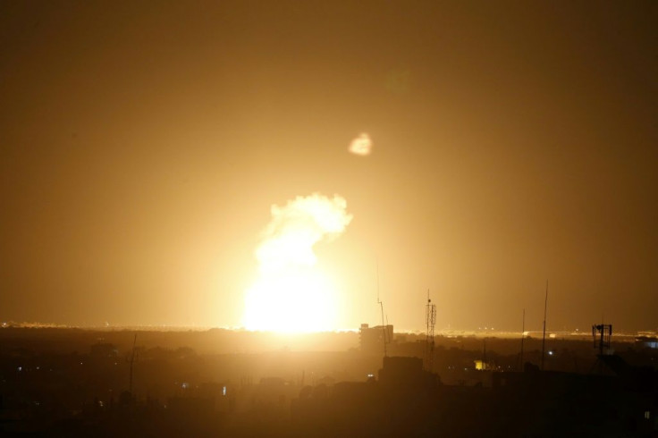 Flames are seen following an Israeli air strike in the town of Khan Yunis, in the southern Gaza Strip, early on November 22, 2020