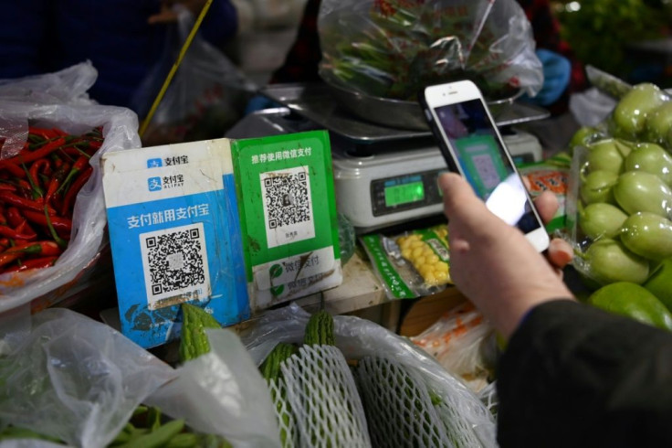 Chinese customers can pay with their smartphones almost everywhere as most businesses display Alipay and WeChat QR payment codes, including a vegetable stand in Beijing