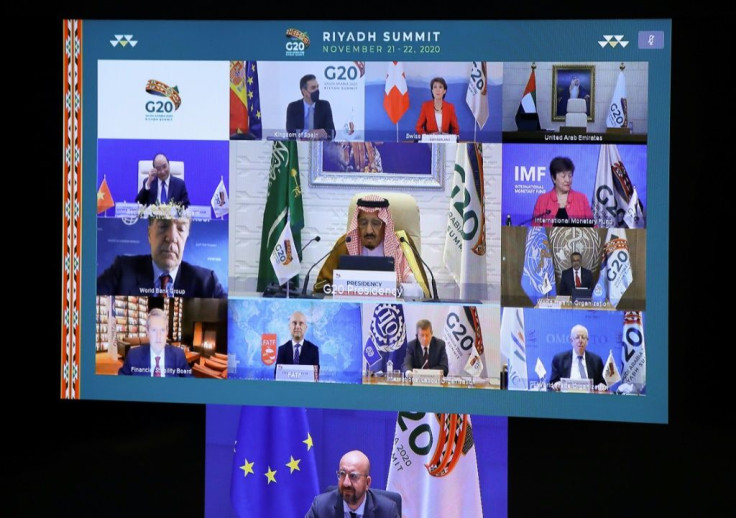 European Council President Charles Michel (down) and Saudi Arabia's King Salman bin Abdulaziz Al Saud are seen with other state and institution leaders on a screen before the start of a virtual G20 summit hosted by Saudi Arabia