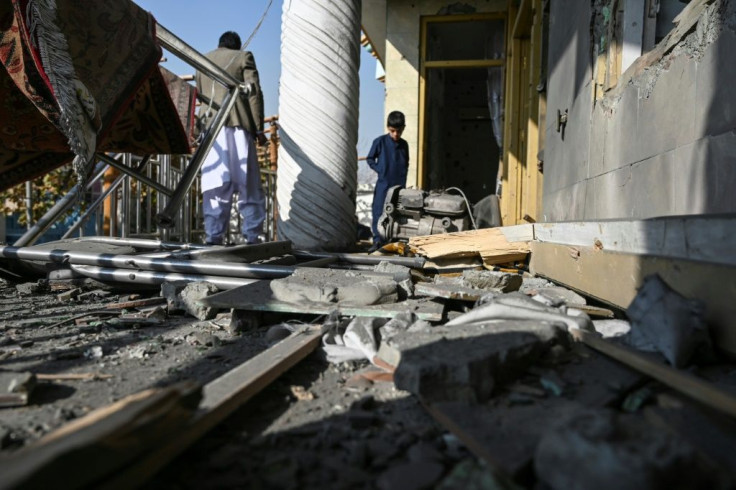 Residents inspect a damaged house in Khair Khana after the rocket attack on Kabul