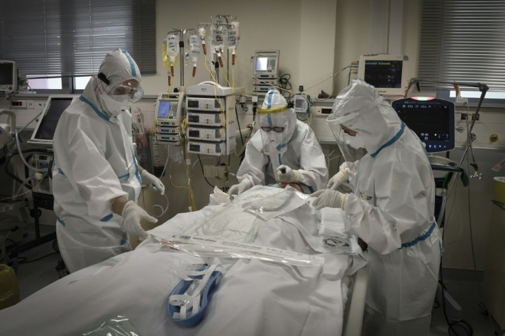 G20 leaders will pledge to "spare no effort" in ensuring the equitable distribution of coronavirus vaccines worldwide. This picture shows nurses helping a Covid-19 patient at an Athens hospital