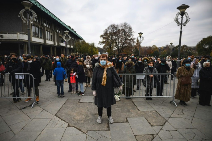 Thousands gathered outside the church, not all of them wearing masks