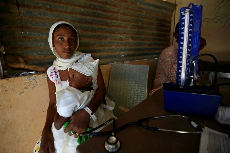 Tens of thousands of Ethiopians have fled fighting into neighbouring Sudan -- here a mother receives medical care at the Um Raquba refugee camp